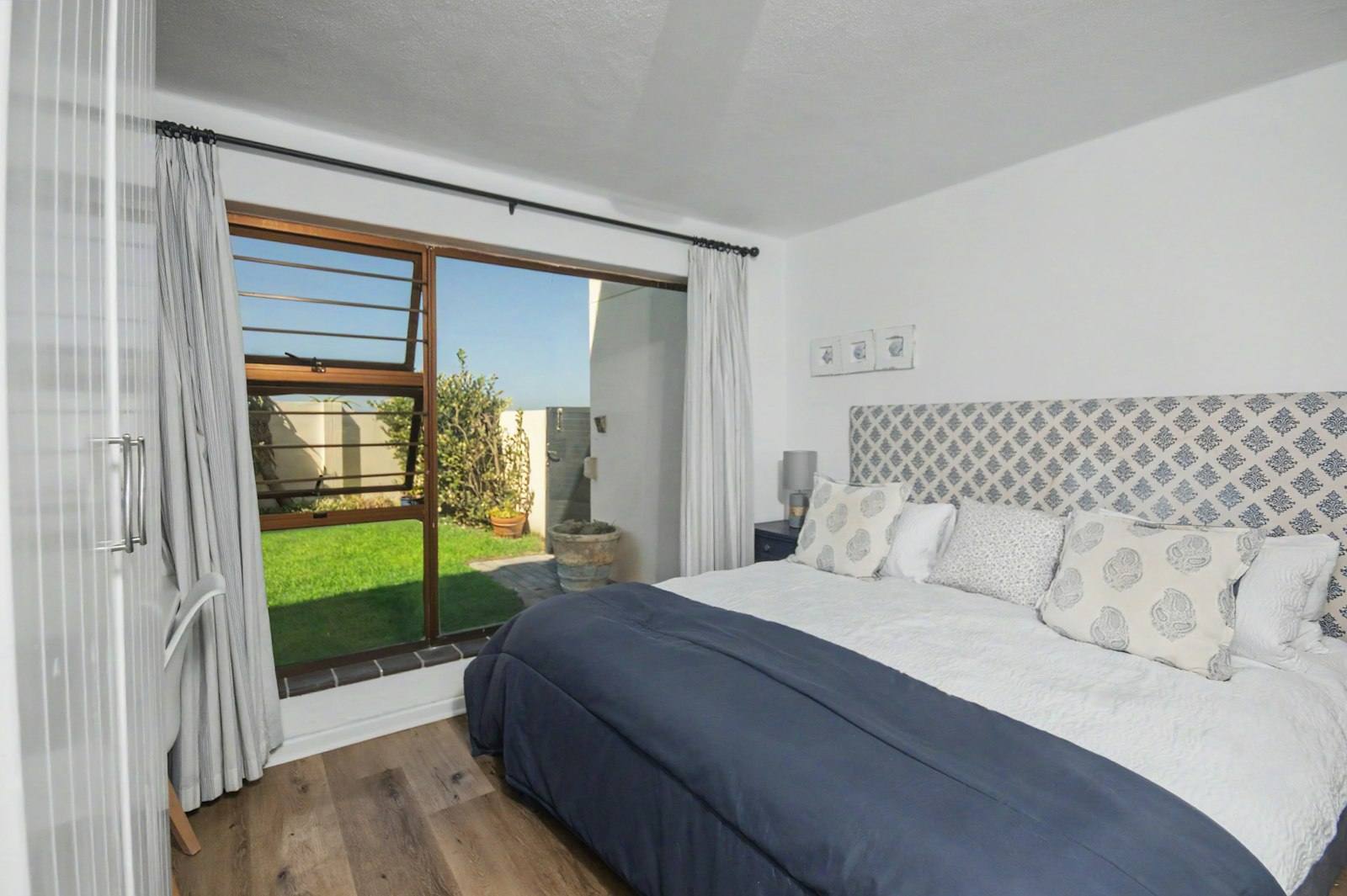 King bedroom with sliding doors onto the garden
