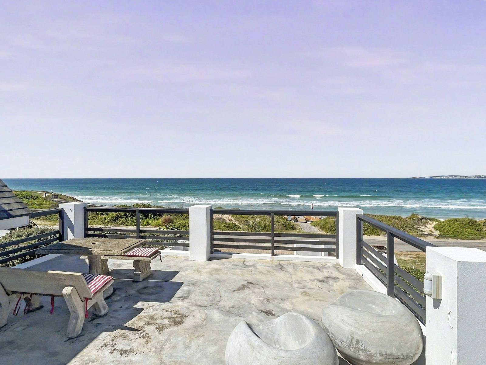 Upstairs deck with stone table and benches looking over the dunes to the ocean